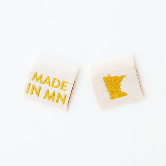 woven sew in labels by Sarah hearts with 'MADE IN MN' text and a map of Minnesota in gold metallic on a cream background