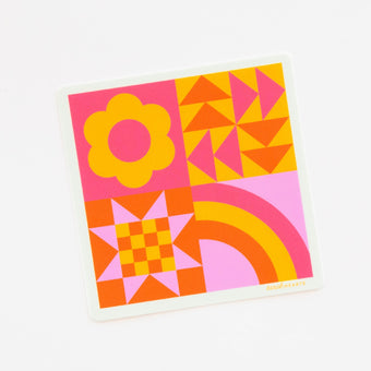 A colorful quilt block sticker featuring a geometric pattern with pink, yellow, orange, and purple colors.