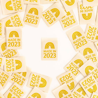 cream woven sew in label with metallic gold rainbow and 2023 sarah hearts year