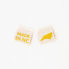 woven sew in labels by Sarah hearts with 'MADE IN NC' text and a North Carolina outline in gold metallic on a cream background