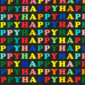 cotton fabric with black background and the word HAPPY repeated in rainbow colors