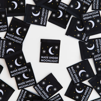 black woven sew-in labels with metallic silver moon and "made under moonlight" text.  By Sarah Hearts.